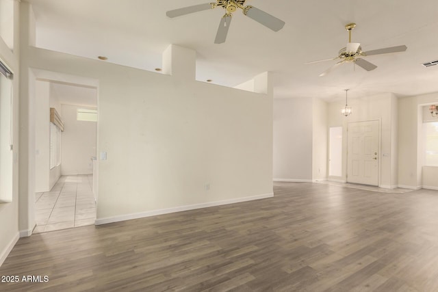 22319 N Desperado Dr, Sun City West, AZ 85375 - unfurnished living room with wood finished floors, baseboards, and a ceiling fan