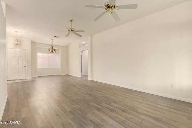 22319 N Desperado Dr, Sun City West, AZ 85375 - empty room featuring wood finished floors, ceiling fan with notable chandelier, baseboards, and visible vents