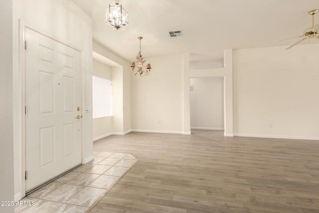 22319 N Desperado Dr, Sun City West, AZ 85375 - interior space featuring light wood-style flooring, baseboards, visible vents, and ceiling fan with notable chandelier