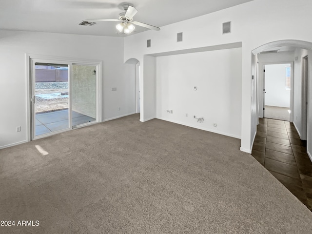 interior space with ceiling fan and dark colored carpet