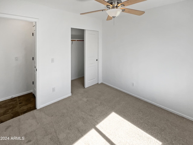 unfurnished bedroom with light colored carpet, a closet, and ceiling fan