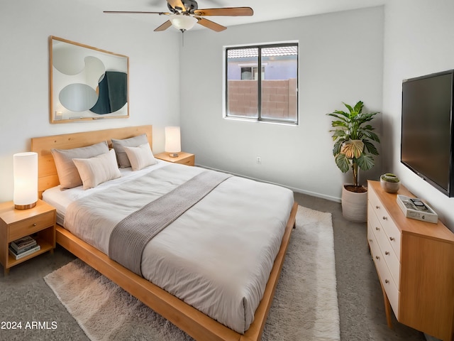 bedroom featuring ceiling fan and dark colored carpet