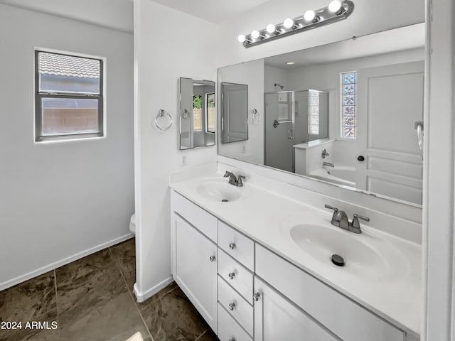 full bathroom with a wealth of natural light, vanity, separate shower and tub, and toilet