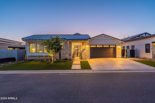 view of front of house featuring a yard and a garage