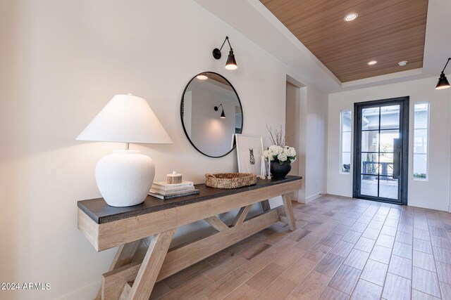 interior space featuring wood ceiling and a raised ceiling