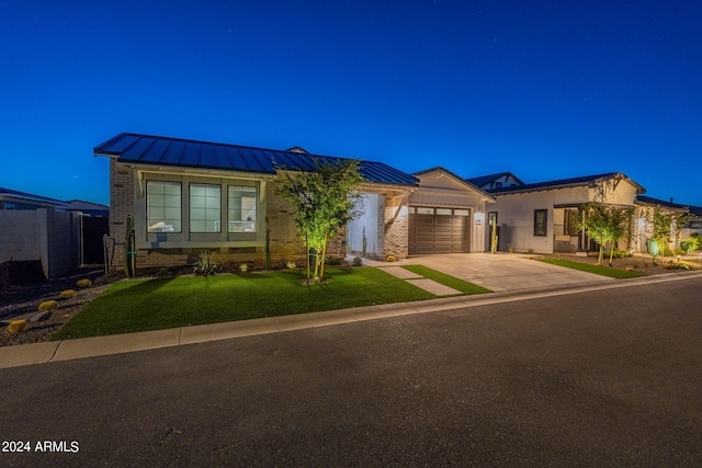 view of front facade with a front lawn and a garage