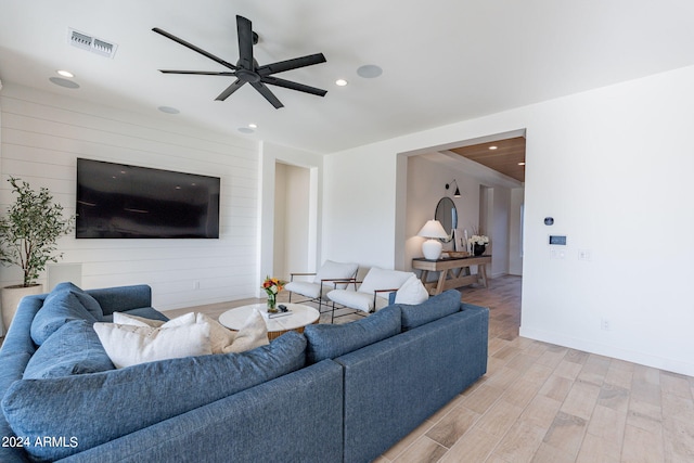 living room with light wood-type flooring and ceiling fan