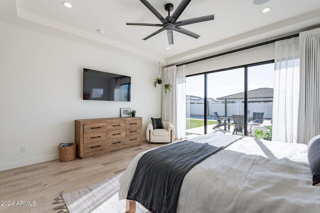 bedroom with light wood-type flooring, ceiling fan, and access to exterior