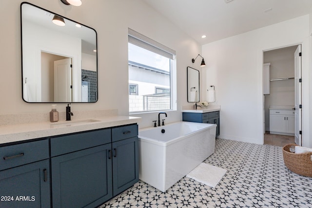 bathroom with a bath and vanity