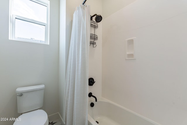 bathroom with shower / bath combo and toilet