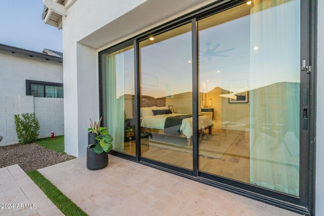 exterior entry at dusk with a patio area