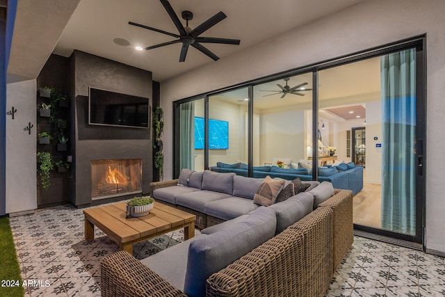 living room with a fireplace and ceiling fan