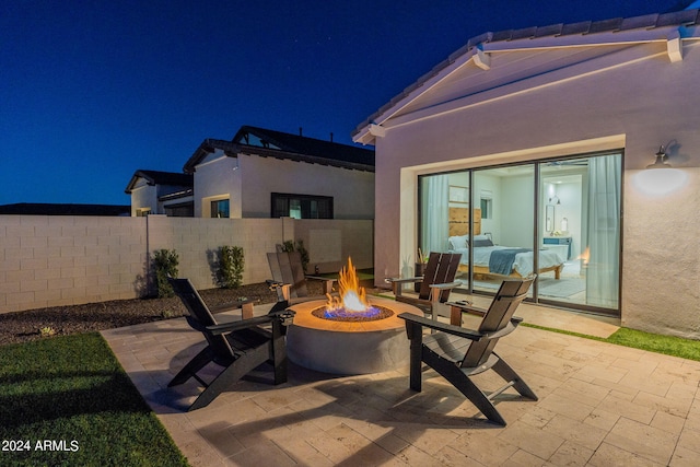 patio at twilight featuring a fire pit