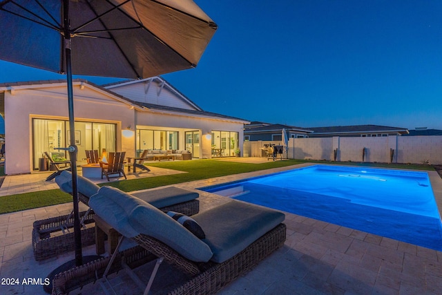 view of swimming pool with a lawn and a patio area