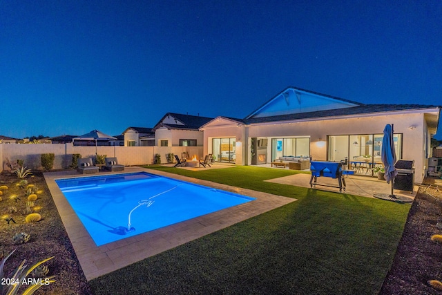 view of pool featuring a patio and a yard