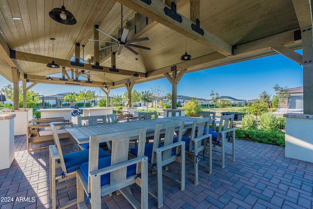 view of patio / terrace featuring a bar and ceiling fan