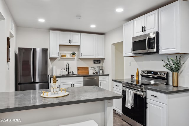 3814 N 36th St, Phoenix, AZ 85018 - kitchen with appliances with stainless steel finishes, white cabinetry, dark wood finished floors, and recessed lighting