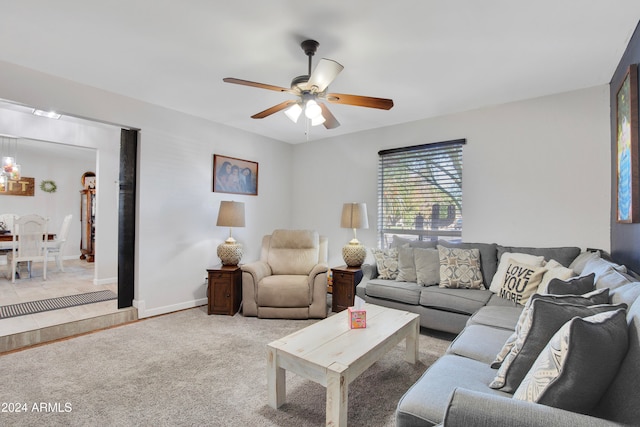 carpeted living room with ceiling fan