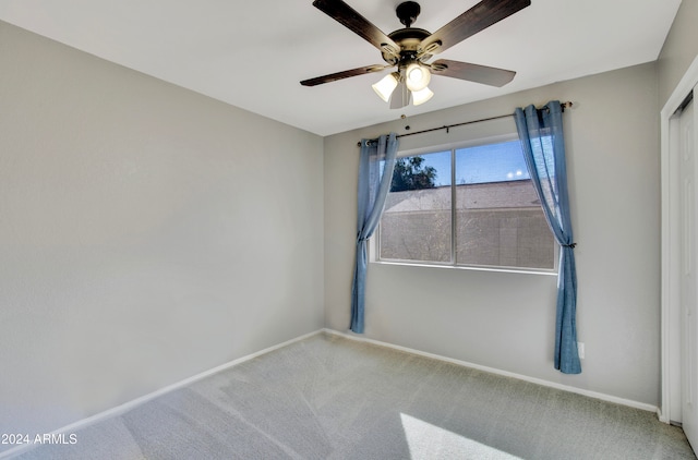 unfurnished room featuring ceiling fan and carpet flooring