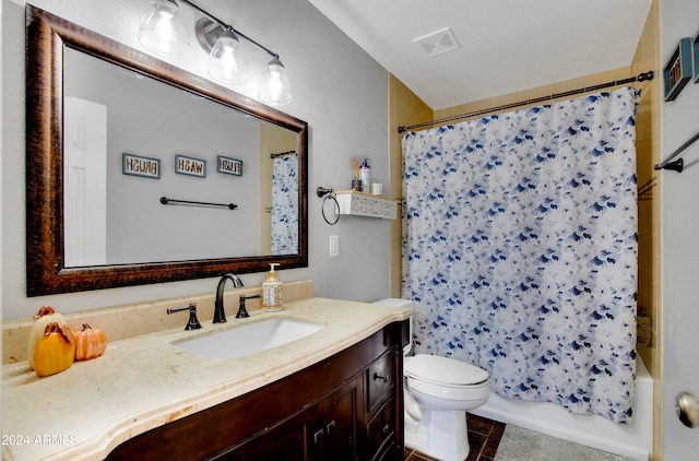 full bathroom with vanity, shower / bath combo with shower curtain, toilet, and tile patterned floors