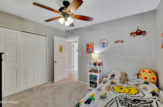 bedroom featuring a closet, ceiling fan, and light carpet