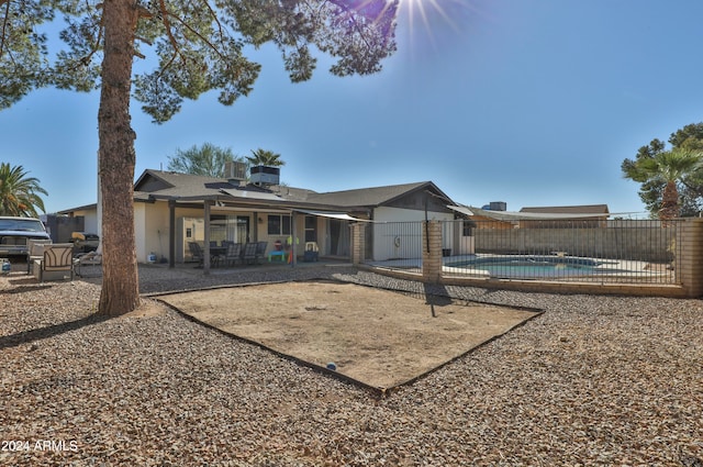 back of house featuring a patio and a fenced in pool