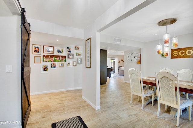 dining space featuring a barn door