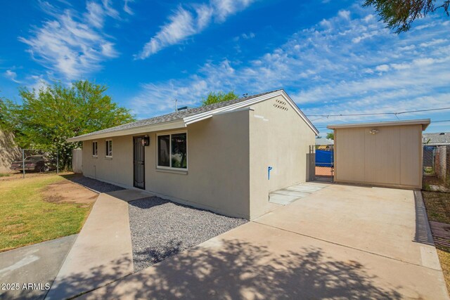 ranch-style home with a patio, a gate, stucco siding, and fence