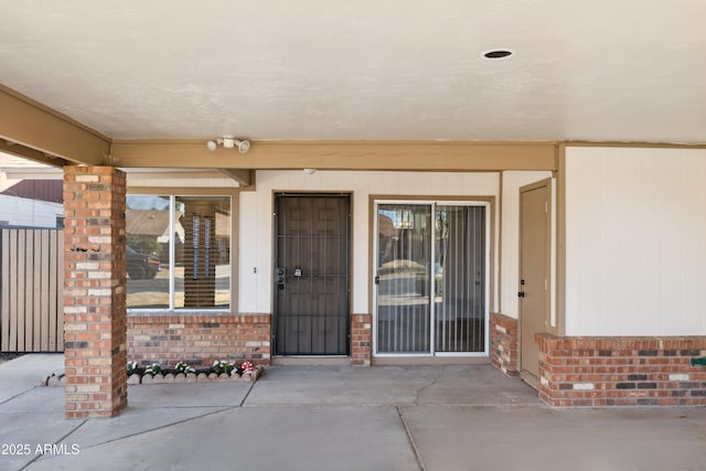 3326 E Calypso Ave, Mesa, AZ 85204 - view of exterior entry featuring brick siding and a patio
