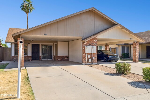 3326 E Calypso Ave, Mesa, AZ 85204 - craftsman house with concrete driveway, brick siding, fence, and a carport