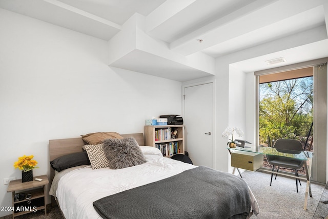 carpeted bedroom featuring beam ceiling