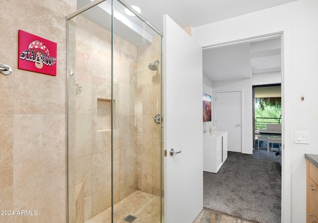 bathroom with vanity and a shower with shower door