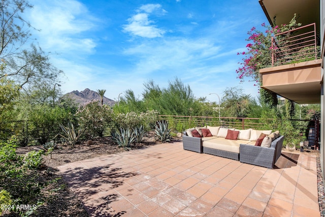 view of patio / terrace featuring an outdoor hangout area, a mountain view, and a balcony