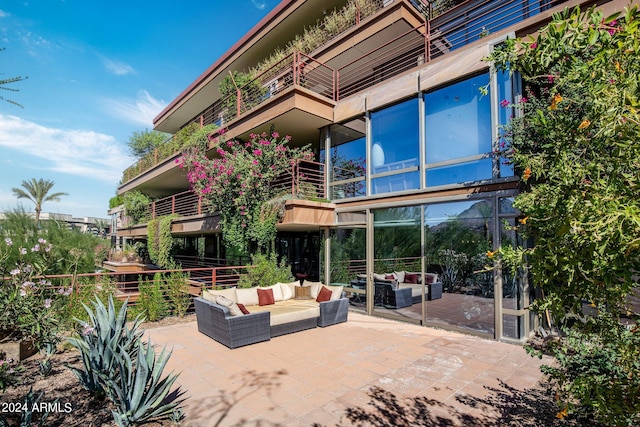 view of patio with outdoor lounge area and a balcony