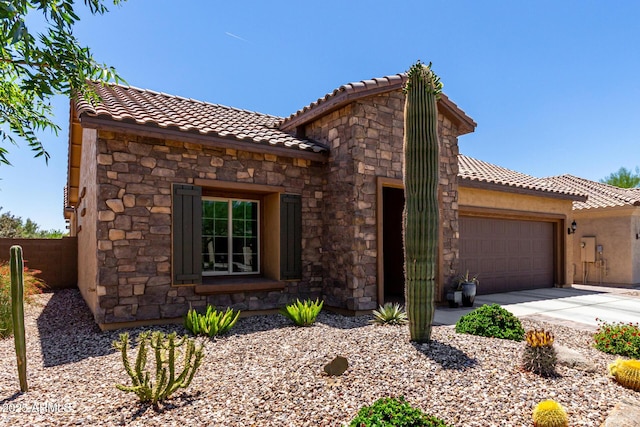 6123 W Sandpiper Way, Florence, AZ 85132 - view of front of house featuring stone siding, a tiled roof, and a garage