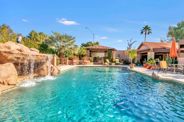 pool with fence, a patio, and a gazebo