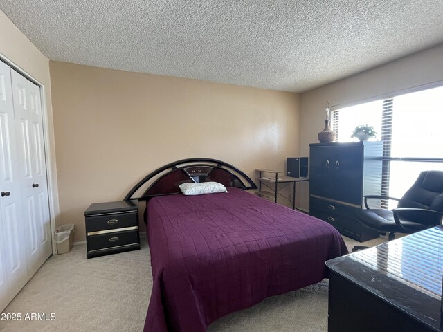 15240 N 51st St, Scottsdale, AZ 85254 - bedroom with a textured ceiling, carpet flooring, and a closet