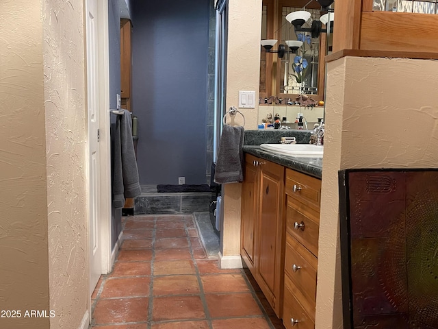 15240 N 51st St, Scottsdale, AZ 85254 - bathroom featuring a textured wall, vanity, and baseboards