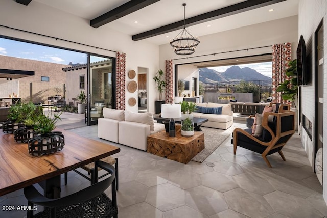 living room featuring beam ceiling and a notable chandelier