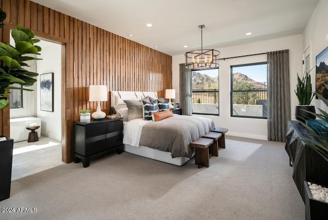 carpeted bedroom with wooden walls and a chandelier