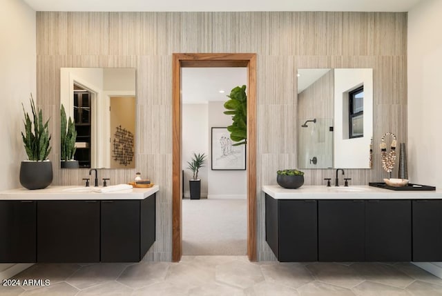 bathroom featuring walk in shower, tile walls, vanity, and tile patterned floors