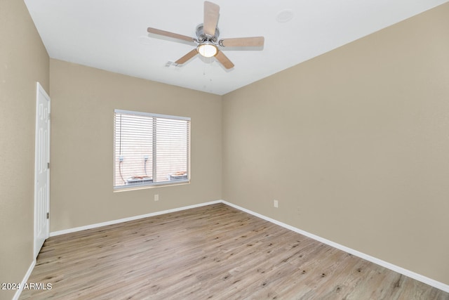 empty room with ceiling fan and light hardwood / wood-style floors