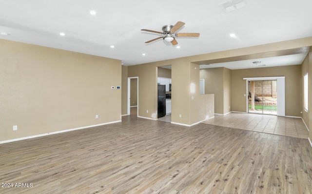 unfurnished living room featuring ceiling fan and light hardwood / wood-style floors