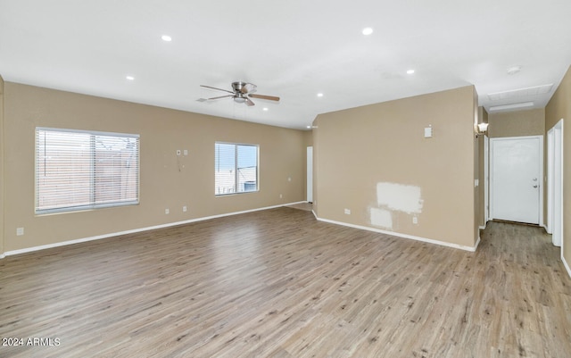 unfurnished living room featuring ceiling fan and light hardwood / wood-style floors