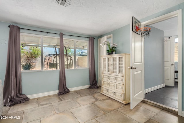 unfurnished bedroom featuring a textured ceiling