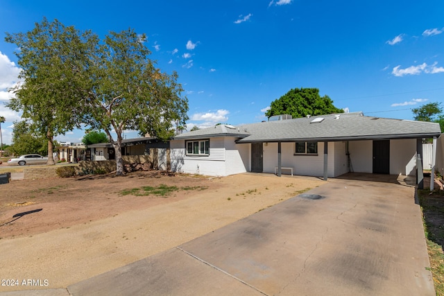 ranch-style house with a carport