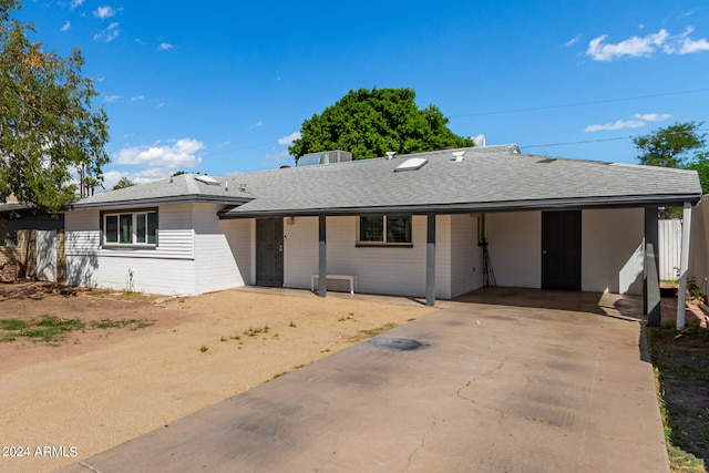 ranch-style home featuring a carport