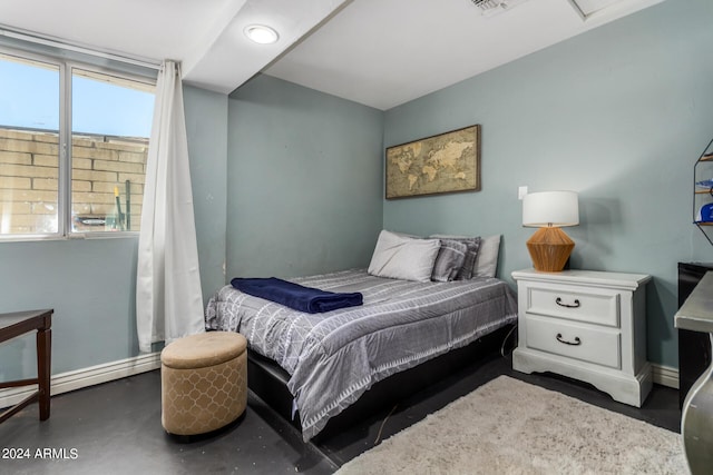 4628 E Holly St, Phoenix, AZ 85008 - bedroom with a baseboard radiator, concrete floors, and baseboards