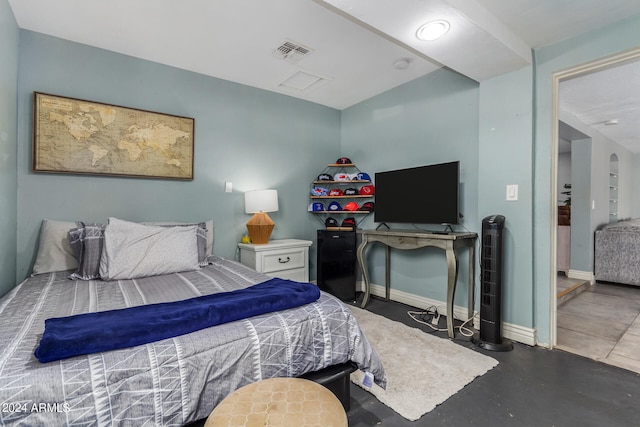 bedroom featuring concrete flooring