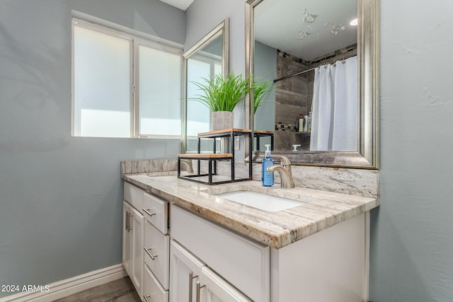 bathroom featuring vanity and curtained shower